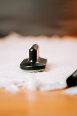 Cleaning vacuum cleaner attachment with brush on a white cloth for better cleaning