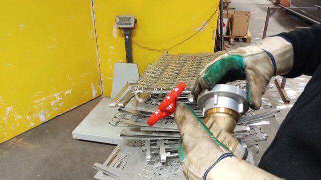 Professional worker assembling 2-inch valve with metal coupling. 