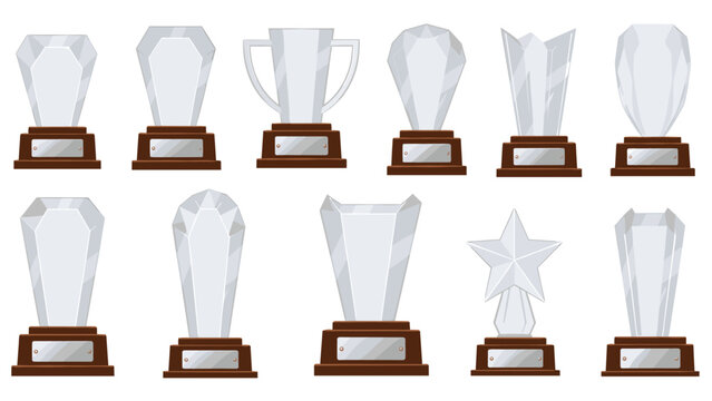 Collection of various glass and crystal award trophies with elegant wooden bases and blank silver nameplates for recognition.