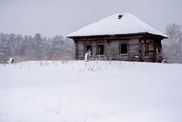 wooden house in the snow