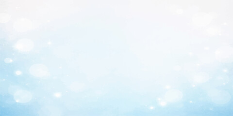 Obraz premium A bright, abstract blue winter background featuring a festive holiday bokeh design with soft, glittering light textures