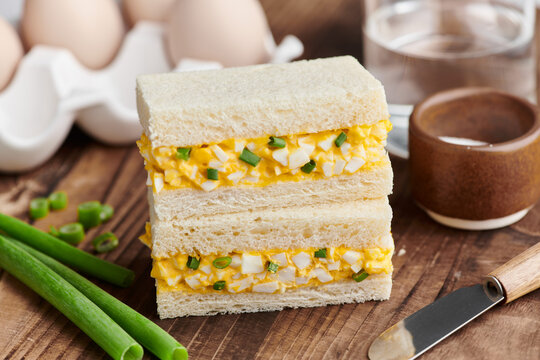 Tamago sando, Japanese egg salad sandwich, on a light background.