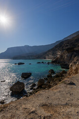 Stunning Turquoise Waters and Rocky Coastline in Oman: Sun Drenched Ar