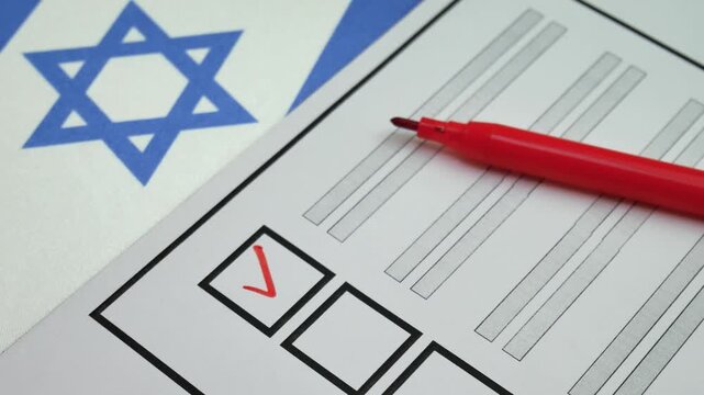 Hand checks box with red marker on ballot. Elections in Israel. National flag in background. Electoral process allows citizens to choose leadership through secure and organized voting system