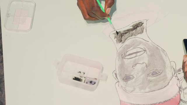 Illustrator practices detailed portrait art. Silently creating detailed portrait with green pencil and supplies. An artist meticulously sketches portrait with careful lines and soft daylight ambiance