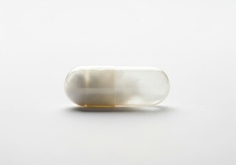 Clear gelatin capsule with white powder on a clean white background