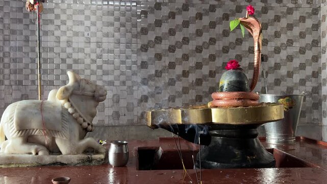 holy shiva lingam with sacred worship and floral offerings in temple interior