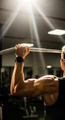 Naklejka premium Dedicated Strength Training: Muscular Arm Working Out in a Gym with Dramatic Lighting