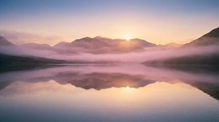Serene mountain lake at sunrise with misty fog