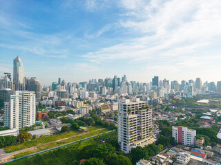 Fototapeta premium Aerial view modern office building with green tropical Lumpini park forest blue sky business travel background Bangkok Thailand