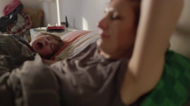 Mother and child sleeping together in bed