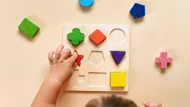 The child collects a multicolored sorter. Educational logic toy for kid's.