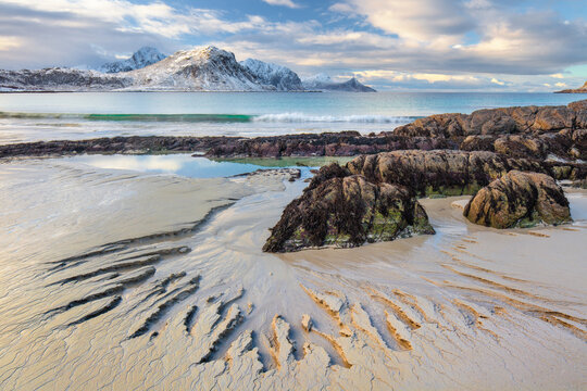 Patterns in the sand on a rocky beach at low tide Haukland beach, Lofoten, Lofoten and Vesteral Islands, Nordland, Norway