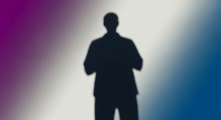 Obraz premium Silhouette of a person standing with hands clasped, mysterious and enigmatic.