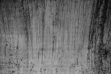 Obraz premium Black and white close up of dripping paint on a textured surface. dark grey gray concrete cement wall floor Abstract Grunge Paint Drips and Splatter Texture on Dark Texture Background backdrop