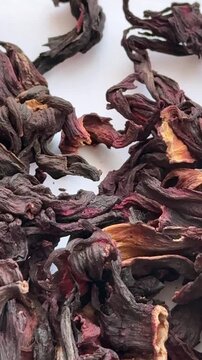 Close-up of deep red hibiscus petals with a natural texture, ideal for visualizing tea, health, and culinary products.