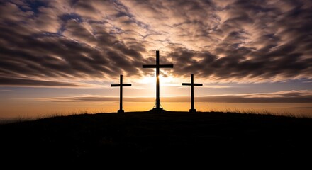 Obraz premium Three Crosses Silhouetted Against Dramatic Sunset.
