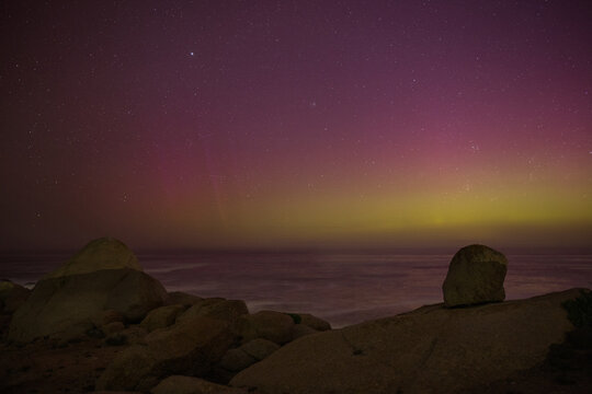 Southern Lights (Aurora Australis) glowing over the coastline at Port Elliott, South Australia.