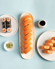 Salmon maki and rolls on a blue background © Uliana
