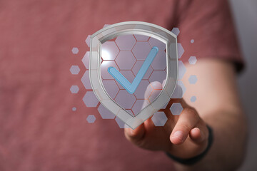 Hand interacting with digital security shield symbolizing safety, protection, and validation in the...