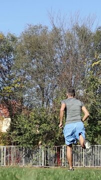 Fit 54 Year Old Man Interval Sprinting on Green Grass. Middle-Aged Man Performing High Intensity Interval Treining. Series Track Code: Fit-Mature-Man-54-Outdoor-Fitness-Series-2024