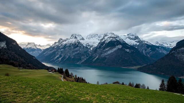  This atmospheric landscape photograph captures a dramatic alpine scene at dusk or dawn, likely in the Swiss Alps.