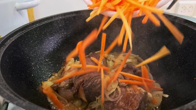 Close-Up of Kazan with Oil Frying Carrots, Onions and Meat