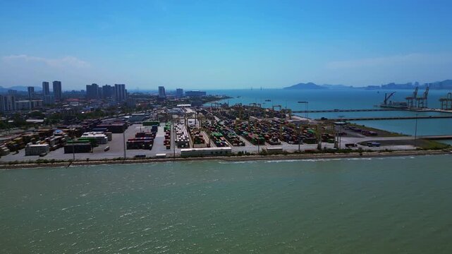 Penang Port's North Butterworth Terminal with numerous shipping containers, cranes, and ships along the coastline. Brilliant aerial view
fly reverse drone