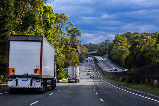 trucks traveling downhill in left lane on divided highway road in NSW Australia