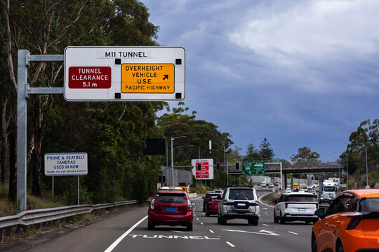 Merging off lane with arrows marked on road towards M11 tunnel in Sydney