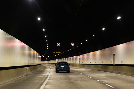 Check your speed sign above road with car traveling through M11 tunnel under Sydney