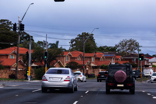 Cars at traffic lights intersection on multi-laned road in city of Sydney