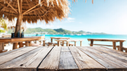 Rustic wooden tabletop in sharp focus, tropical beach bar with blurred ocean background, summer vacation concept
