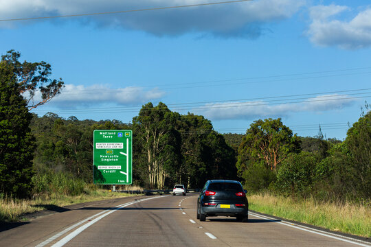 Green roadside sign with directions to hunter expressway Newcastle link road the M1 and M15
