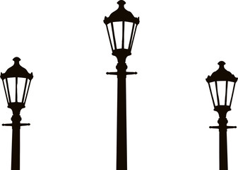 Silhouette of three classic street lamps on poles