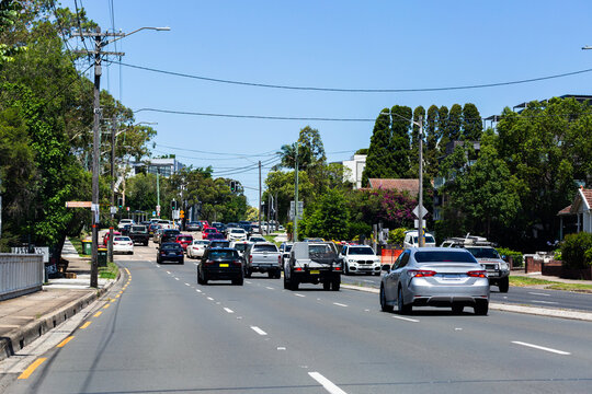 Traffic driving on multilane city street with clearway to roadside
