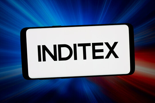Stuttgart, Germany - 02-25-2026: In this photo illustration, the logo of Industria de Diseno Textil S.A. (Inditex) is displayed on a smartphone in front of abstract background on computer screen.
