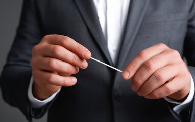 Magician Preparing for an Incredible Trick with a Cotton Swab in Hands