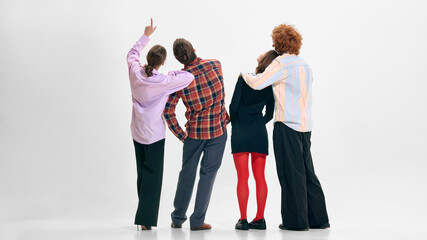 Business team from behind pointing in upright direction. Concept of long term strategy alignment, shared corporate roadmap and collective ambition in contemporary organization. © master1305