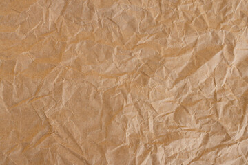 Fototapeta premium Crumpled Brown Kraft Paper Texture Background,Top view of brown crumpled recycled kraft paper texture. Abstract wrinkled paper background with rough creases and shadows, perfect for organic,