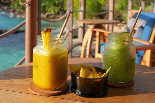 View of a cold pina colada cocktail in a tropical setting