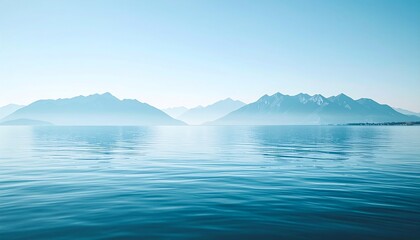 Serene seascape with distant mountains under a clear sky.