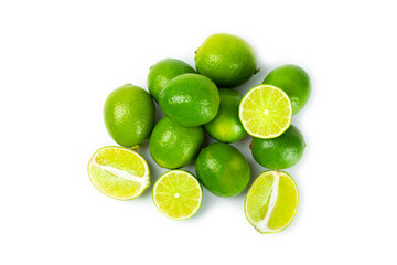 Fresh lime isolated on white background. Whole limes and slices in a bowl. Citrus. Vitamin C. Detox diet. Tropical fruits. Summer refreshing lemonade or mojito concept.