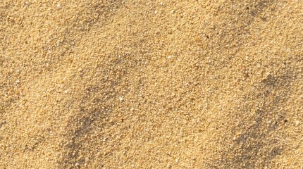 Close-up detailed texture of fine golden sand, showing individual grains and subtle shadows casting natural patterns across the surface