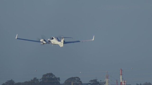 Small twin-engine propeller plane taking off