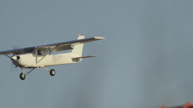 Small propeller airplane landing on runway