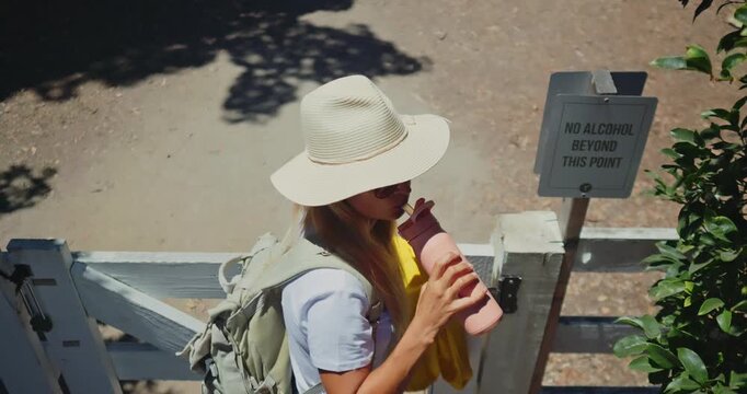 Woman Drinking Smoothie at No Alcohol Sign in Sunny Garden