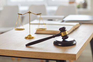 Justice balance scales, gavel of judge and legislation book on desk of lawyer. Wooden table with...