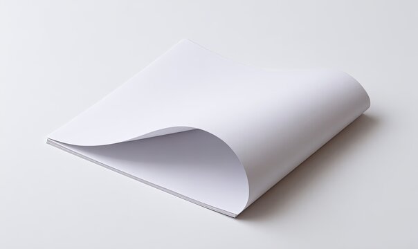 Crisp, white paper pages; top page curled, revealing the layered sheets. Studio, clean lighting