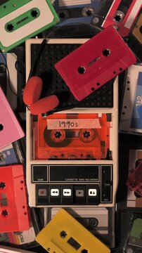 Vintage cassette tape recorder playing 1990s music. Vertical